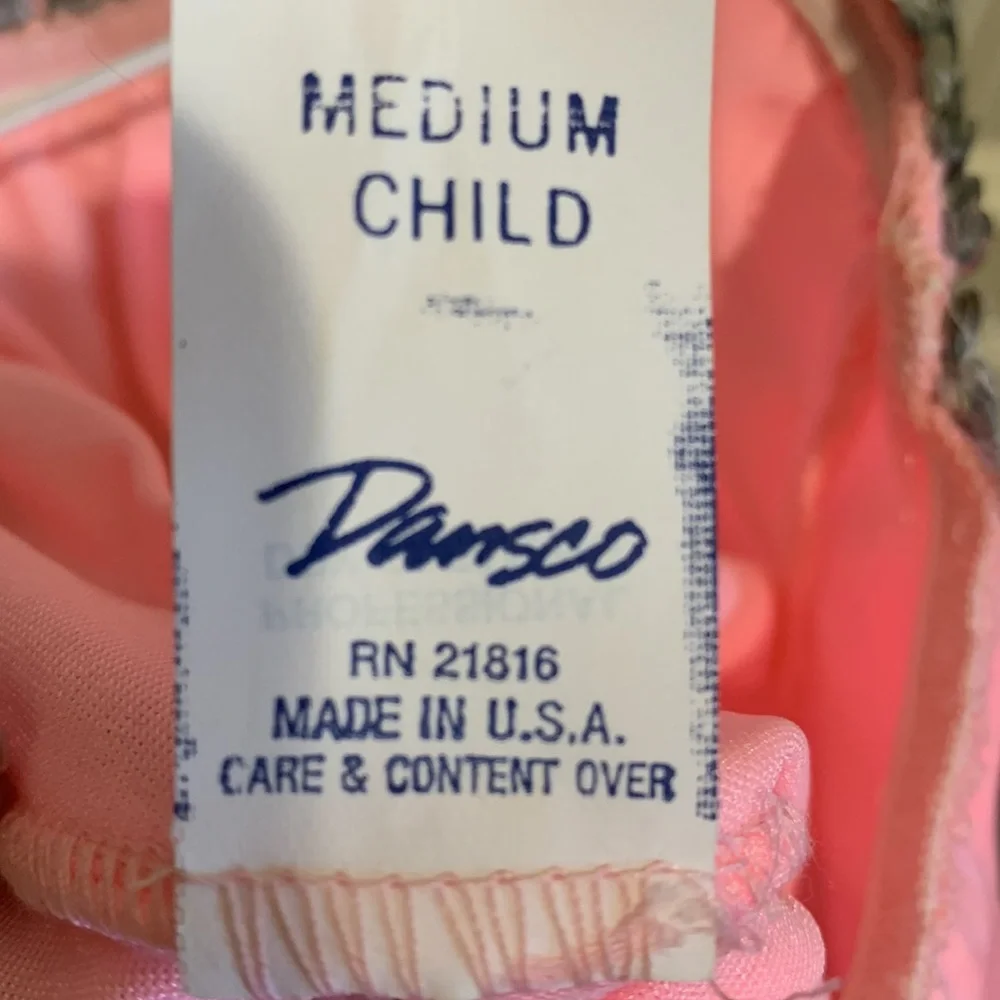 Dansco pink leotard with halter tie and trimmed in silver sequins